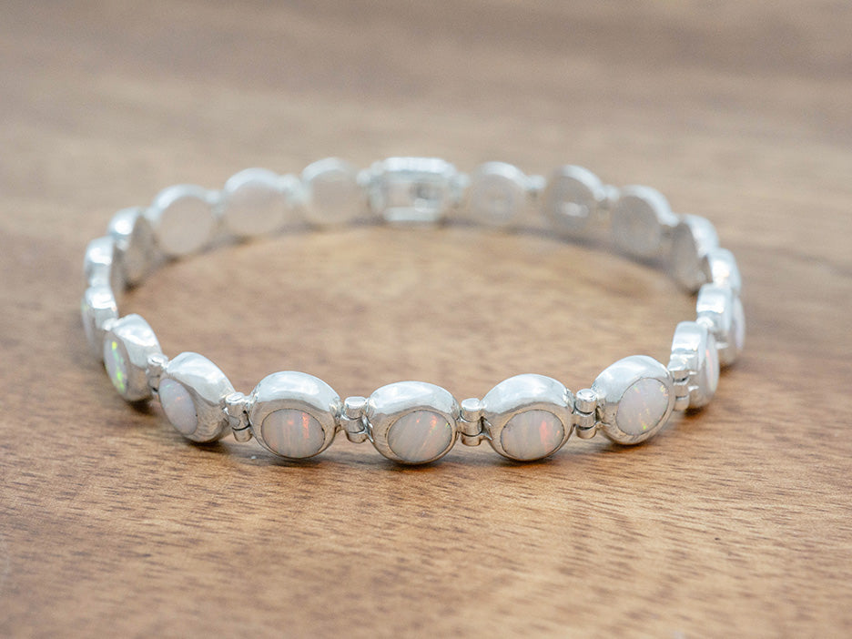 a petite bracelet of white opal cabochons set in sterling silver