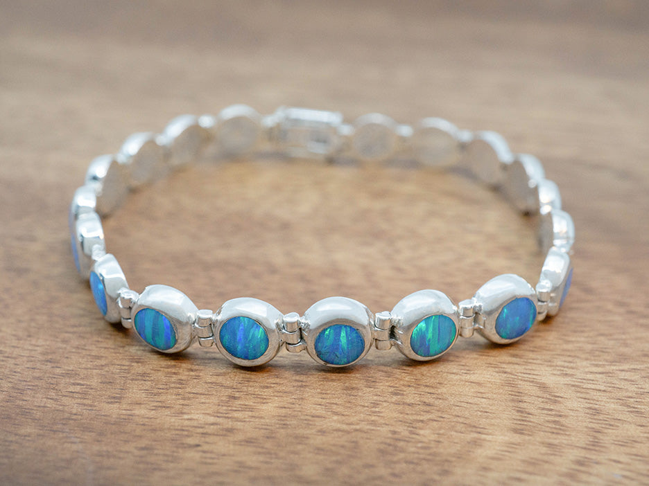 a dainty bracelet of linked blue opal cabochons set in sterling silver. 