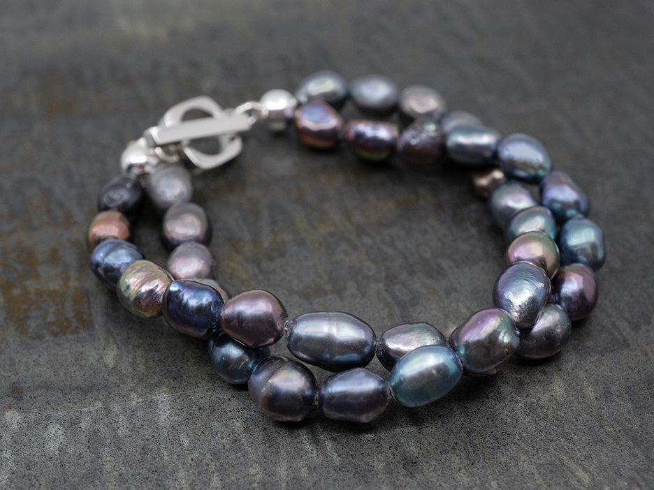 A two-strand black pearl bracelet with a sterling silver toggle closure