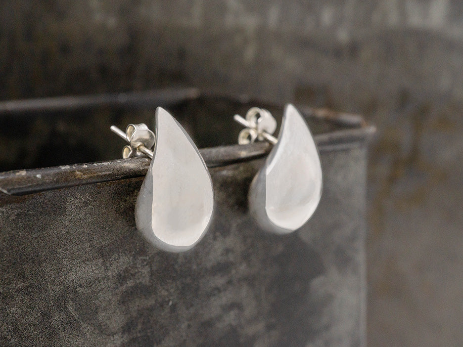puffed teardrop earrings with a subtle curve that makes them look like a comma