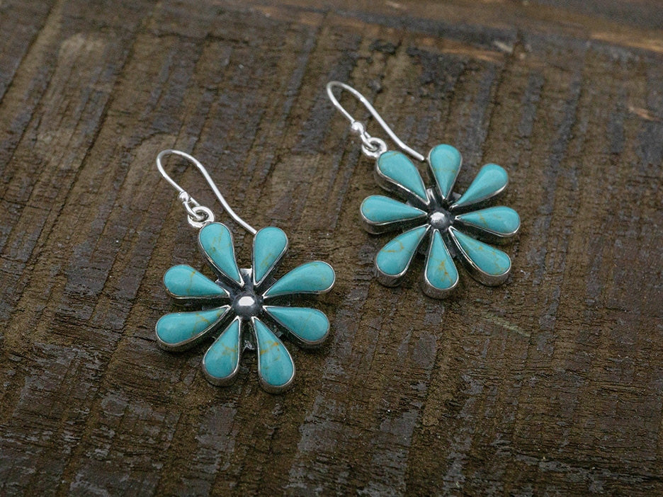 A pair of turquoise flower earrings set in sterling silver.