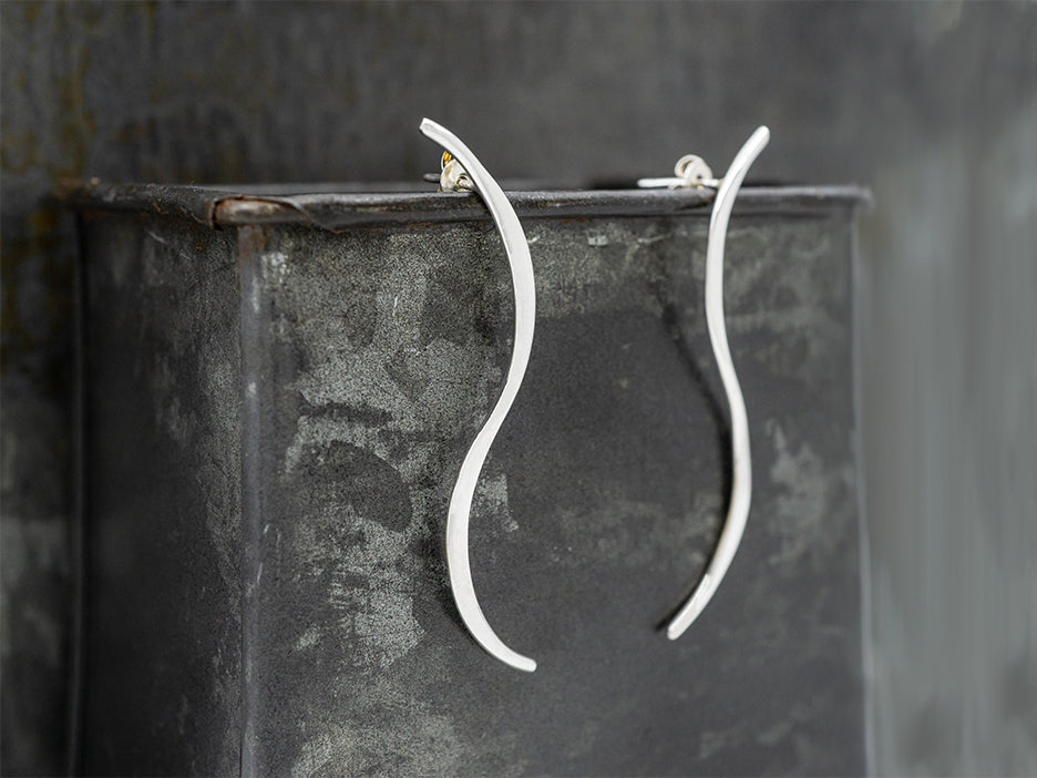 S-shaped sterling silver earrings on posts.