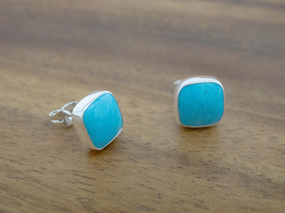 Stud earrings made with turquoise stones set in sterling silver.