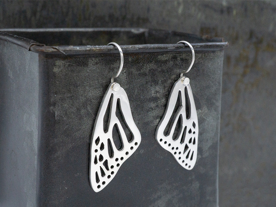 Sterling silver monarch butterfly wing earrings on hook.