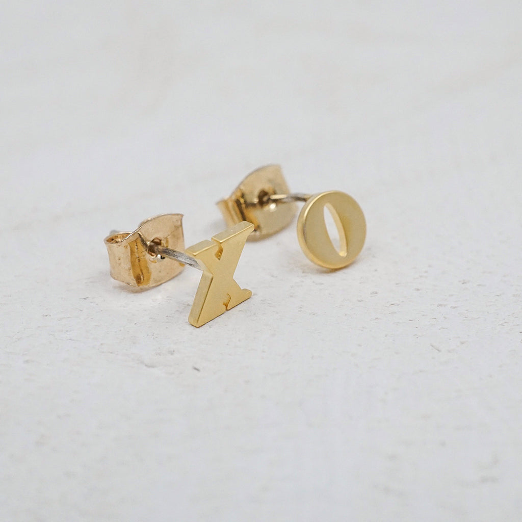 Mismatched X and O yellow gold-filled stud earrings.