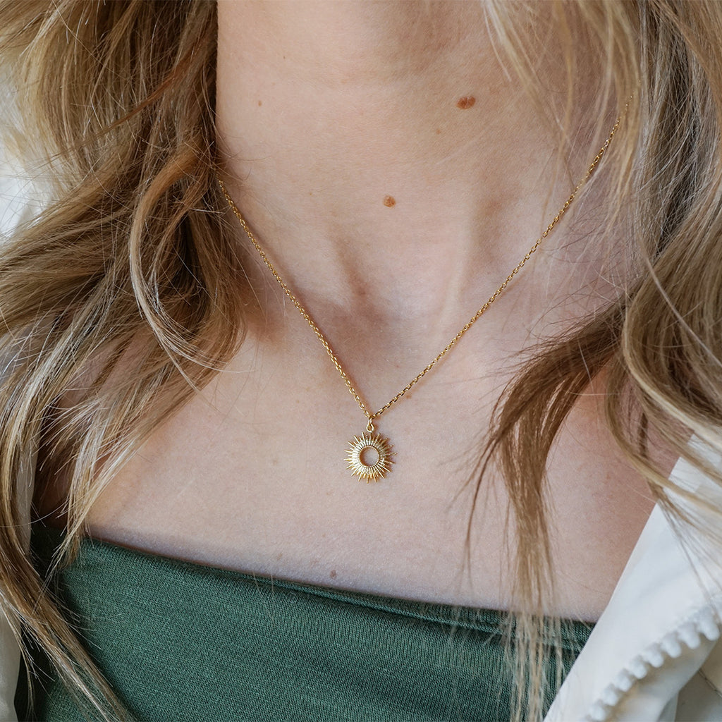 Dainty yellow gold-filled necklace with a radiant circle at the center.