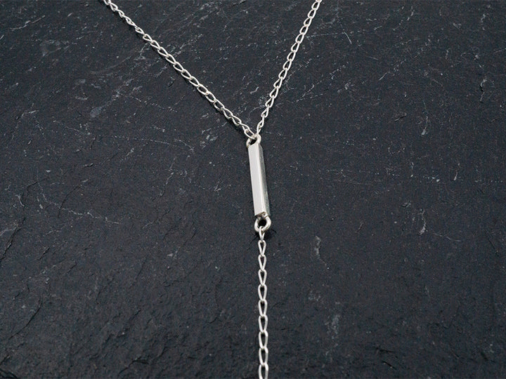 Sterling silver lariat necklace with an 8" drop and pendulum dangle.