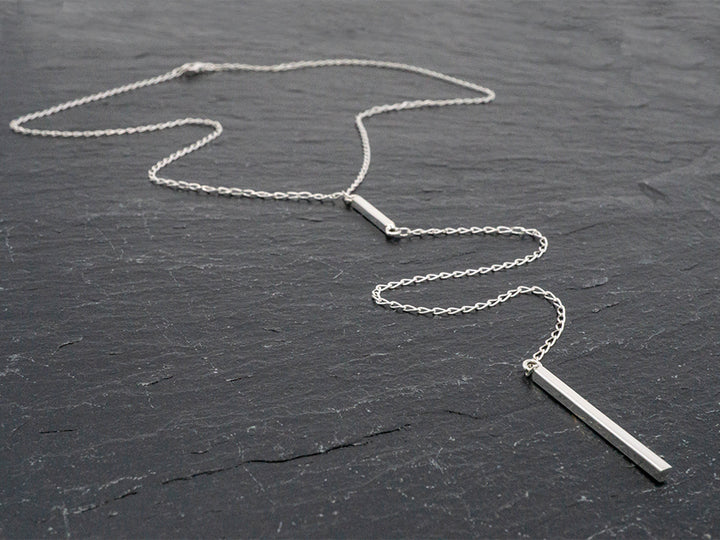 Sterling silver lariat necklace with an 8" drop and pendulum dangle.