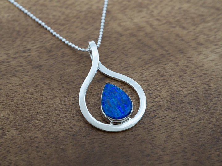 dark blue opal teardrop pendant with a sterling silver frame