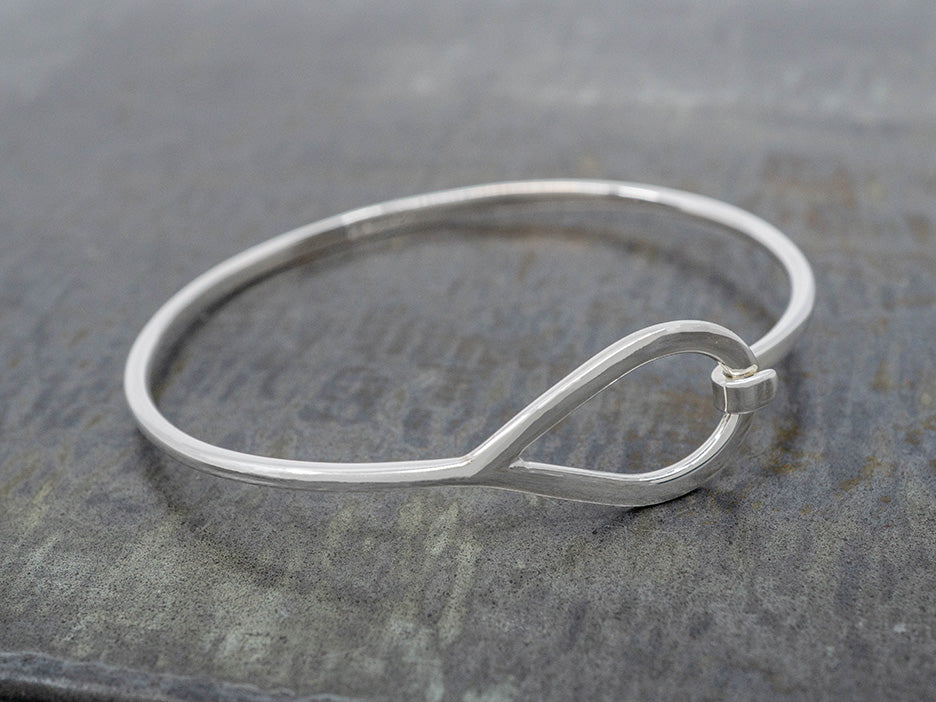 Silver bracelet on a textured gray surface