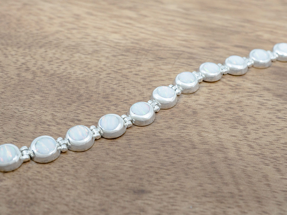 a petite bracelet of white opal cabochons set in sterling silver