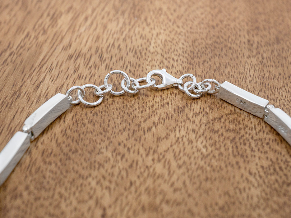 A sterling silver linked bracelet toggle clasp.
