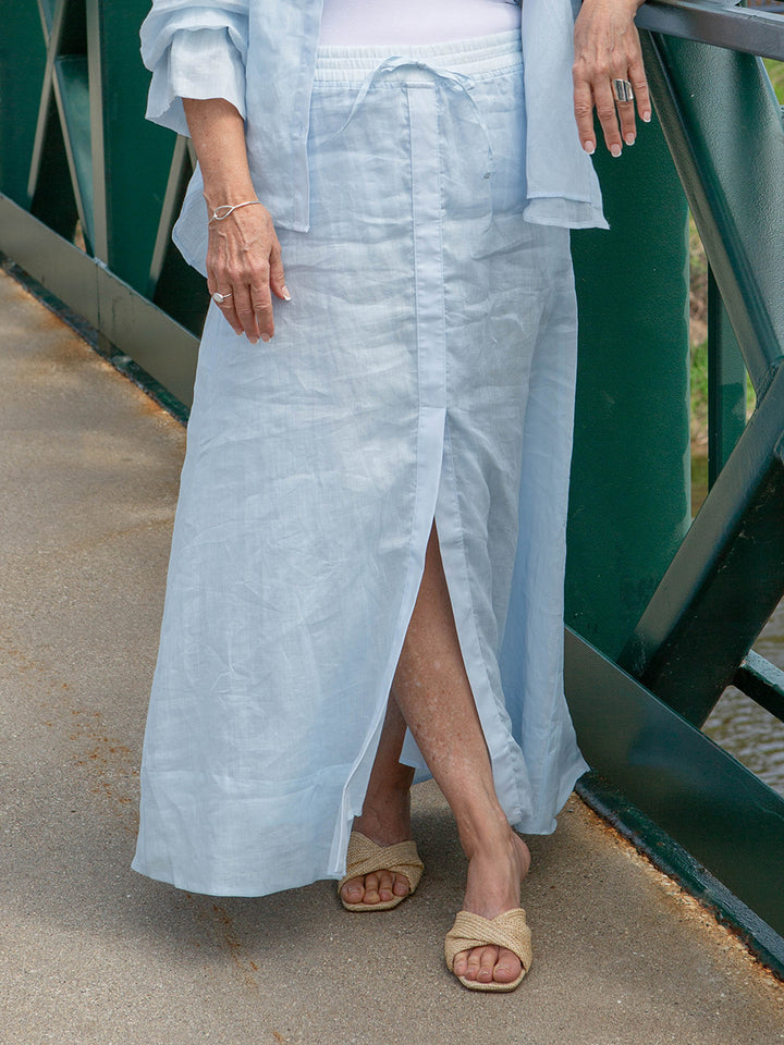 woman wearing a light blue maxi skirt with a front slit