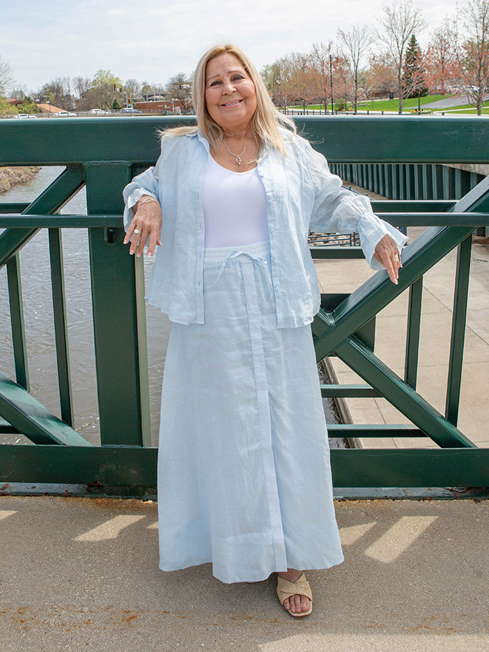 woman wearing a light blue blouse and matching skirt