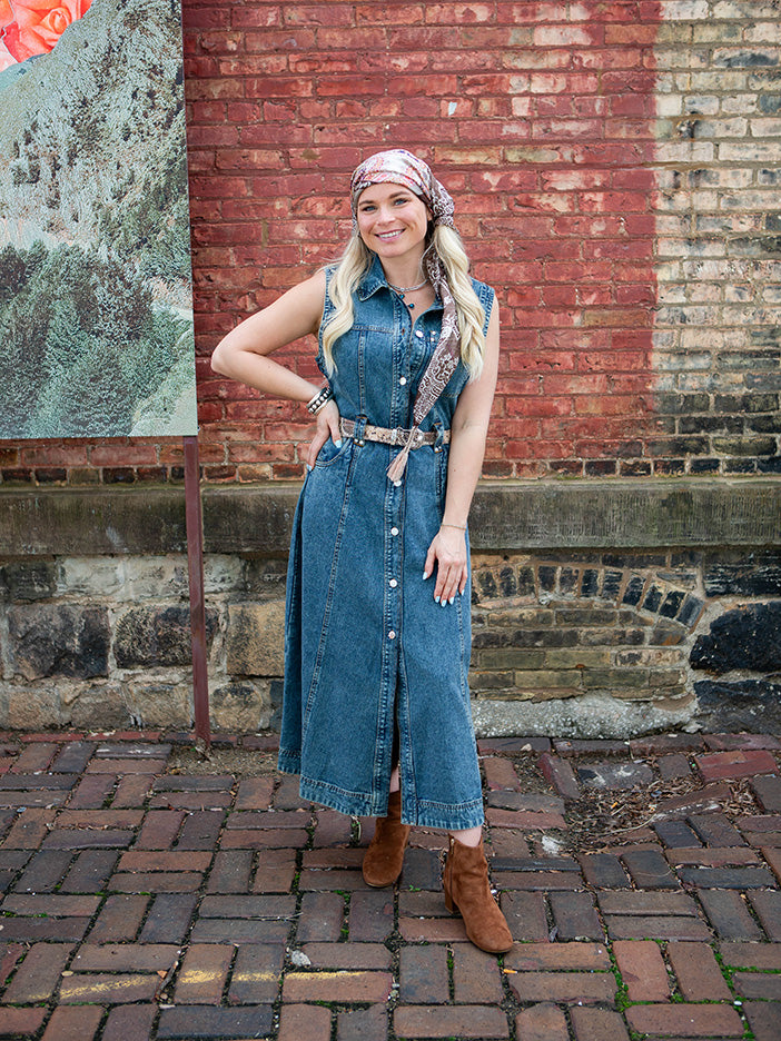 A woman wearing a blue denim maxi dress