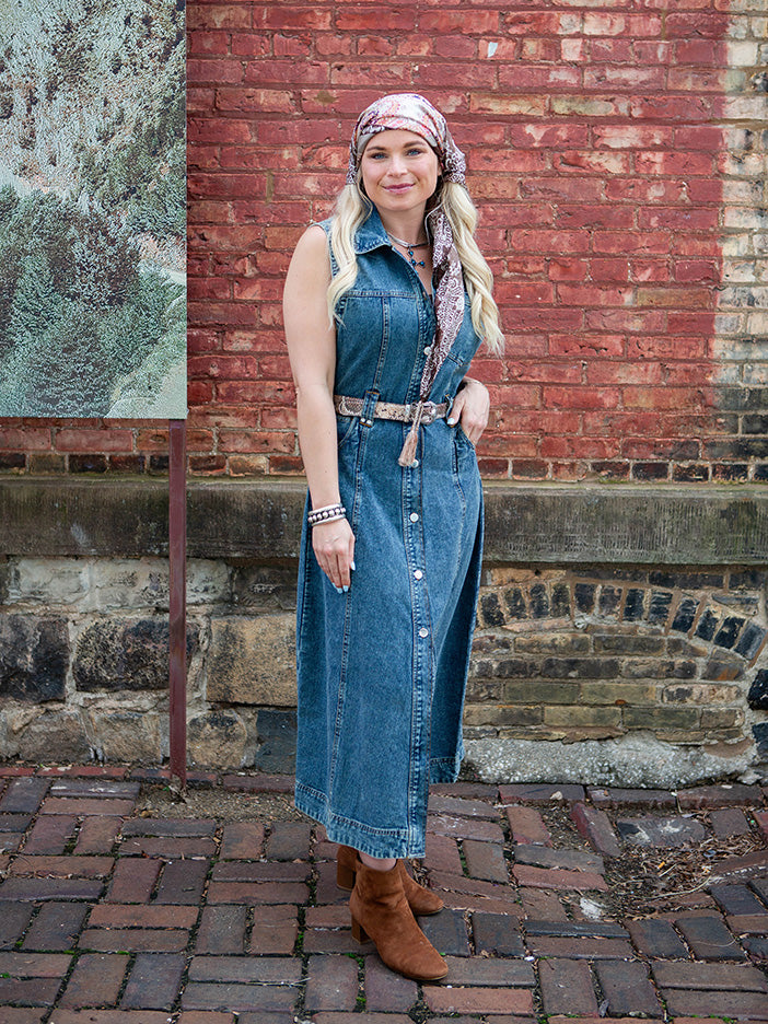 A woman wearing a blue denim maxi dress