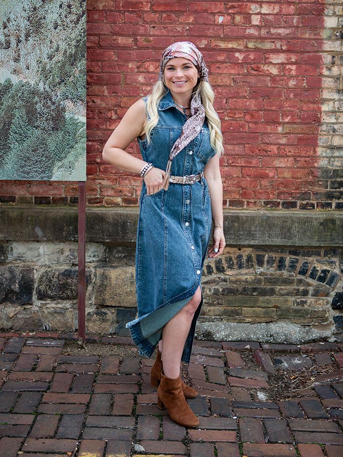 A woman wearing a blue denim maxi dress
