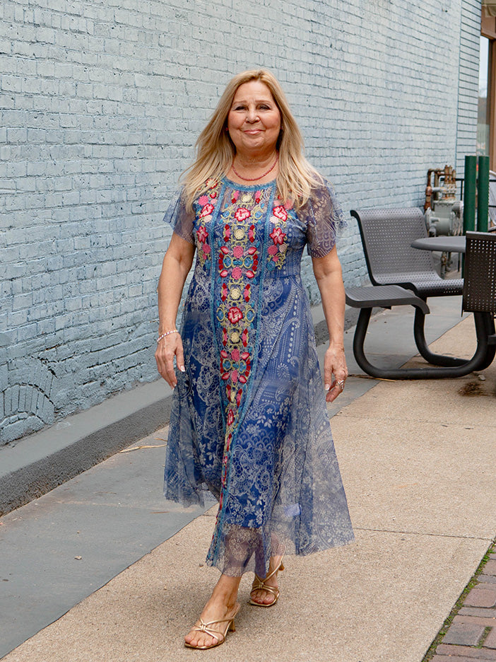 woman wearing a blue patterned dress.