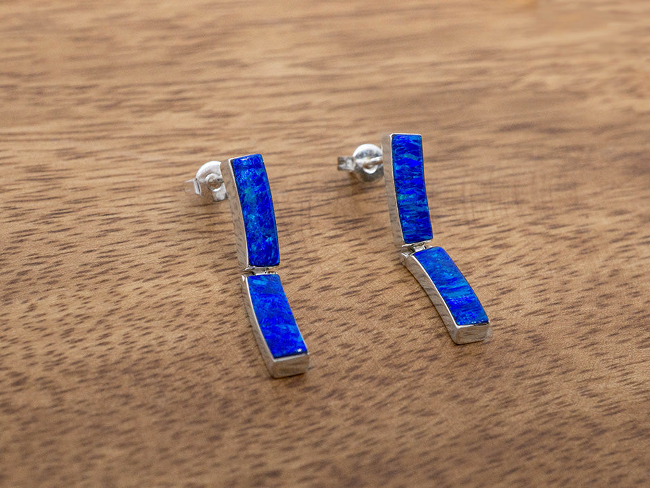 A pair of sterling silver post earrings with 2 rectangular links of dark blue opal.