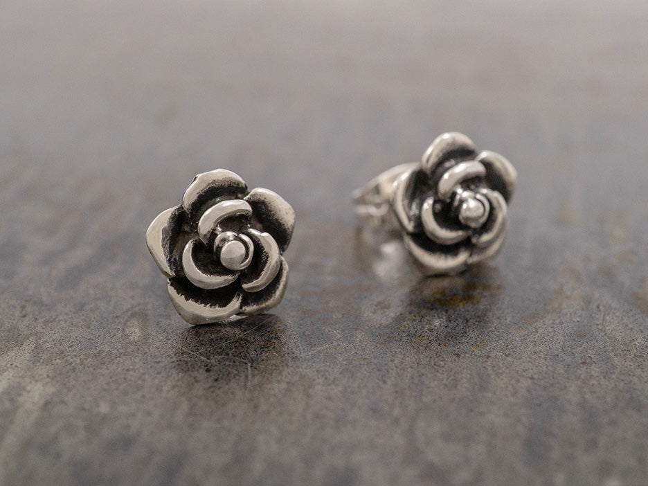 Sterling silver flower studs with oxidized details.