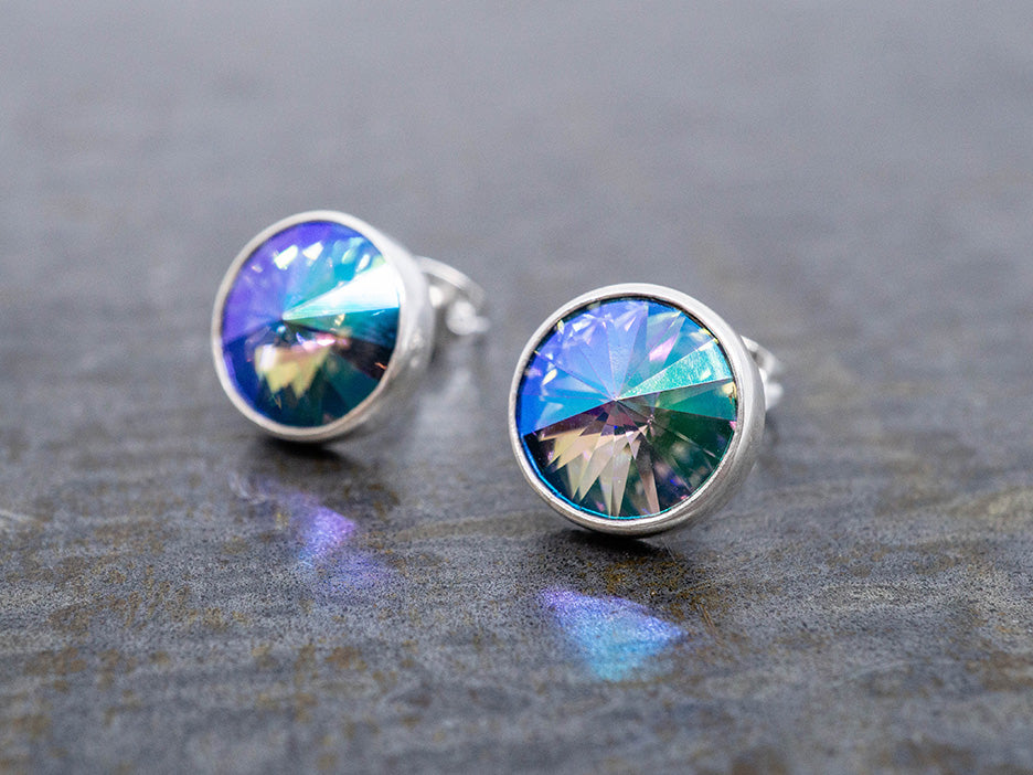 Multicolored crystal earrings on a dark surface