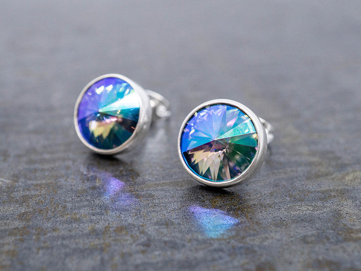 Multicolored crystal earrings on a dark surface