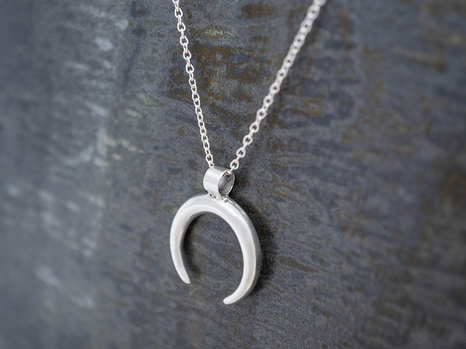 a sterling silver crescent pendant on a 16" chain