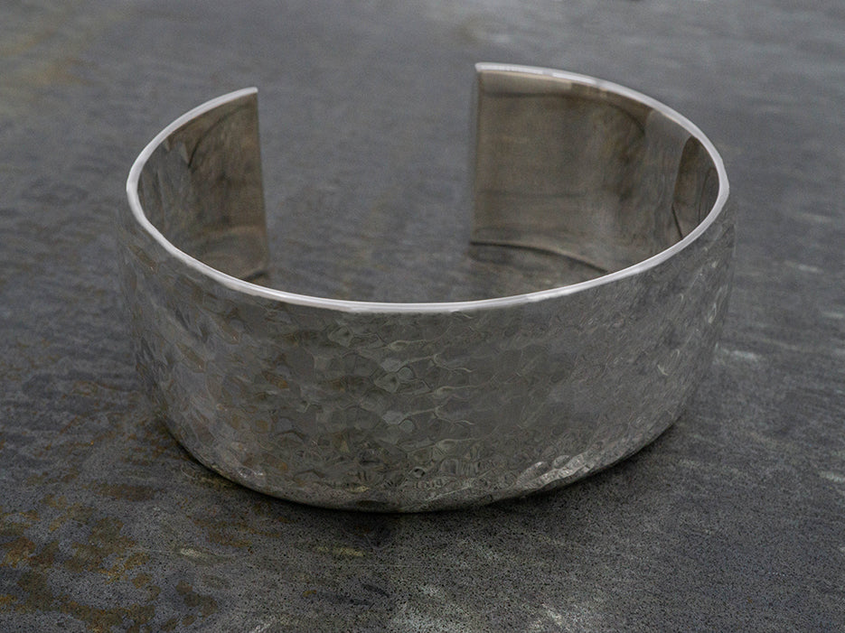 Wide, hammered sterling silver cuff bracelet.