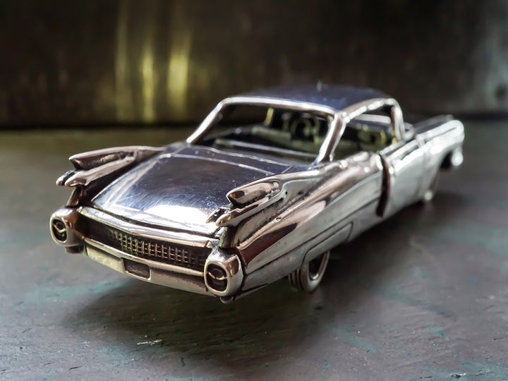 Sterling silver die-cast model of a 1959 Cadillac.