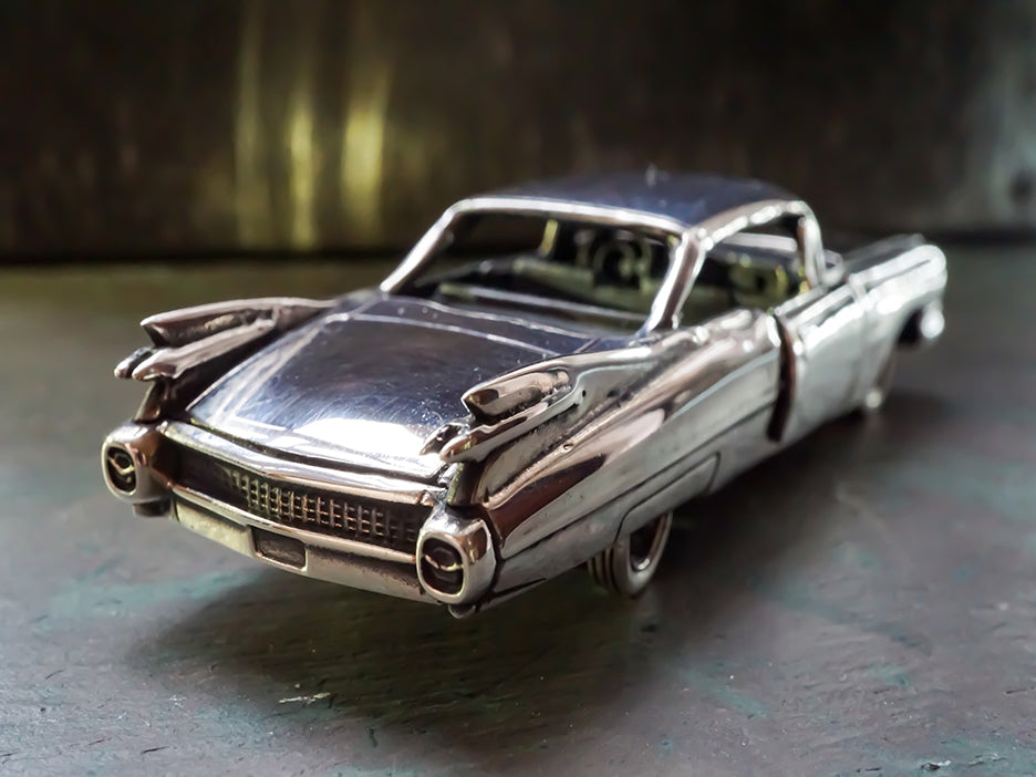 Sterling silver die-cast model of a 1959 Cadillac.