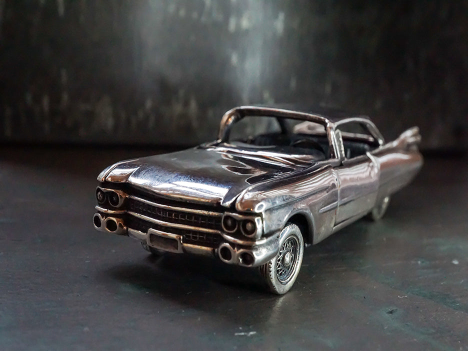 Sterling silver die-cast model of a 1959 Cadillac.