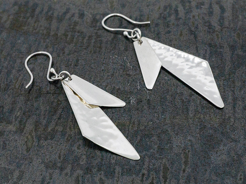 A hook earring made with two sterling silver quadrilaterals, one hammered and one smooth.