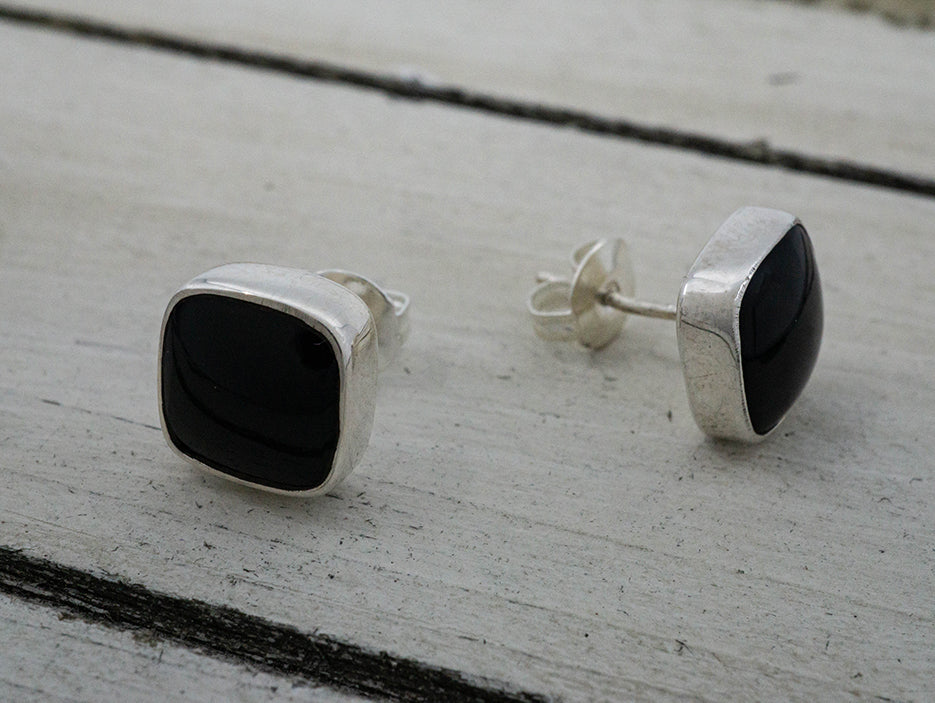 stud earrings made with black onyx stone squares set in sterling silver.