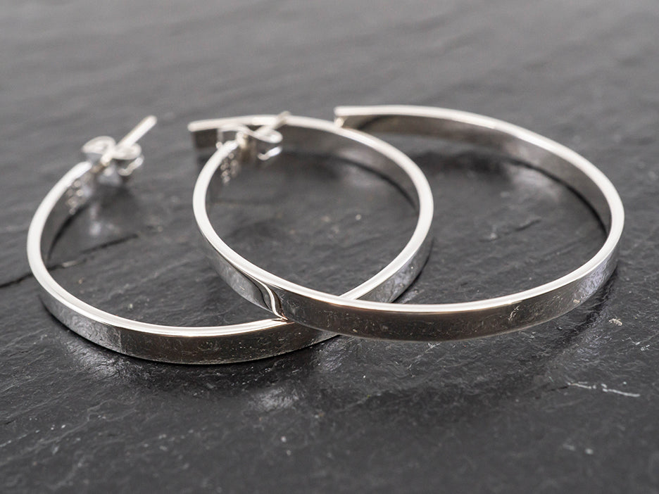 Sterling silver hoop earrings.