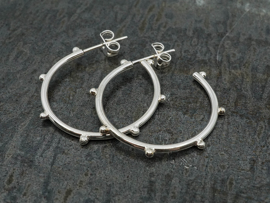 Urban-style 1" sterling silver hoop earrings with beads. 