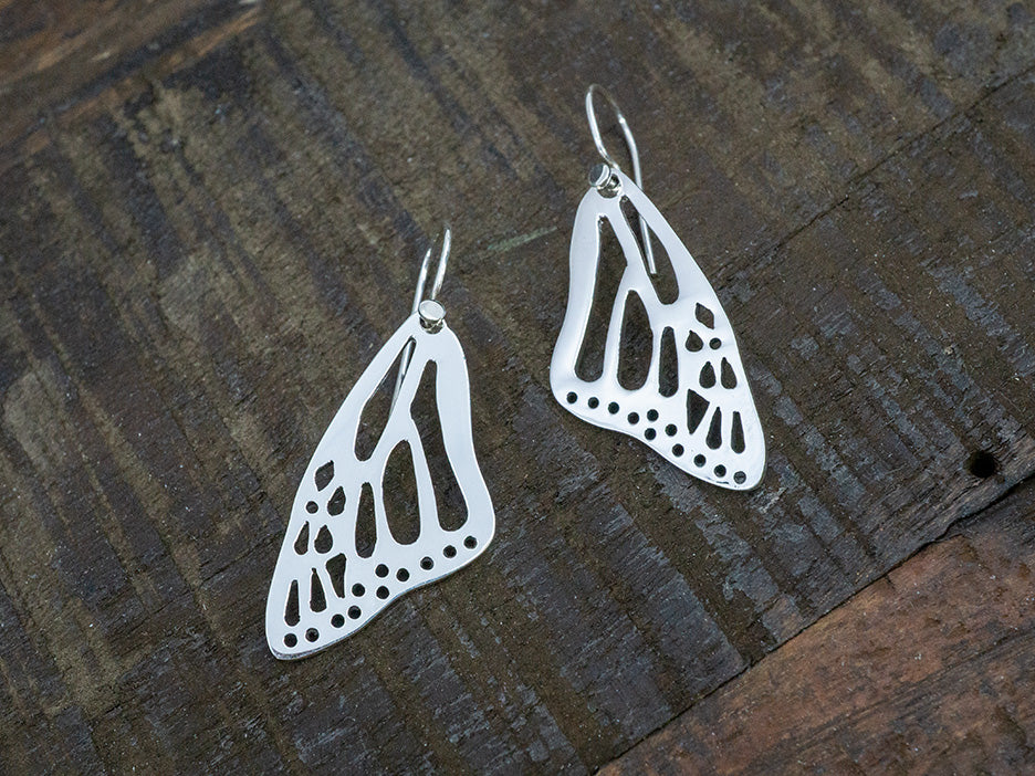 Sterling silver monarch butterfly wing earrings on hook.