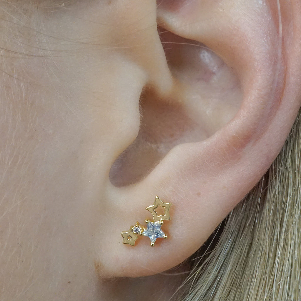 Dainty gold-filled earrings with gold and cubic zirconia stars.