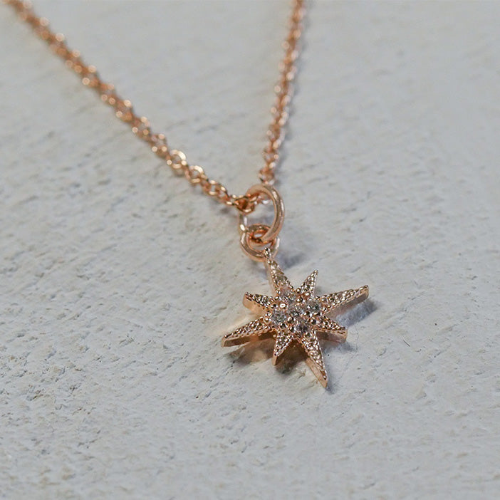 Dainty rose gold necklace with a pave-style star pendant.