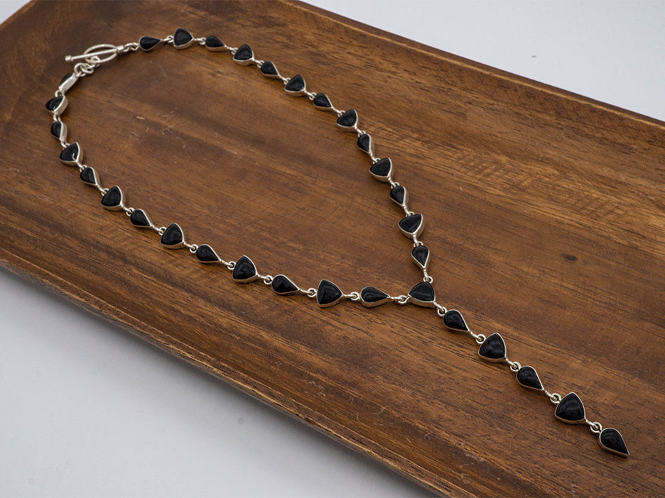 Sterling silver lariat necklace with black stones. 