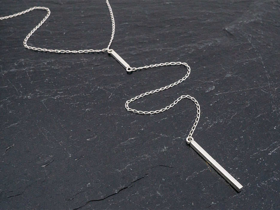 Sterling silver lariat necklace with an 8" drop and pendulum dangle.