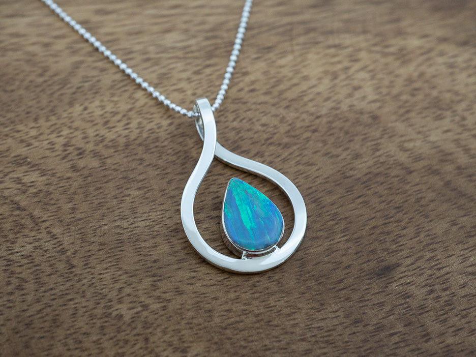 light blue opal teardrop pendant with a sterling silver frame
