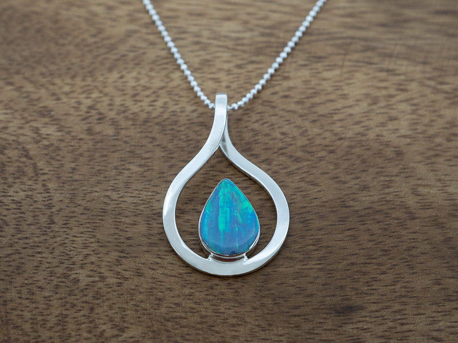 ight blue opal teardrop pendant with a sterling silver frame