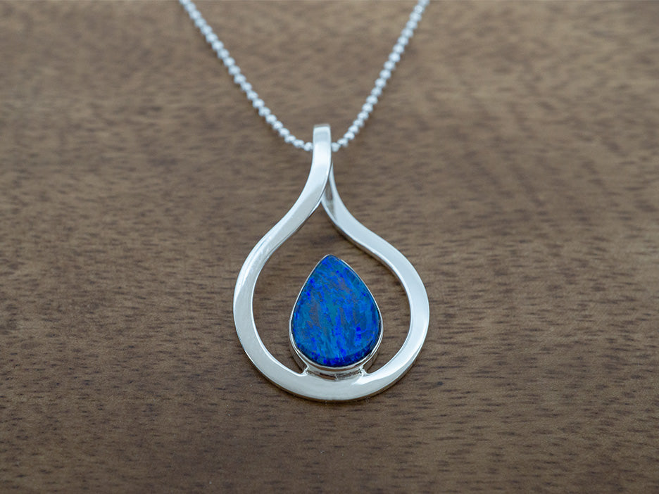 dark blue opal teardrop pendant with a sterling silver frame