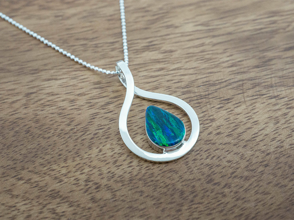 A green opal teardrop pendant in a sterling silver frame.