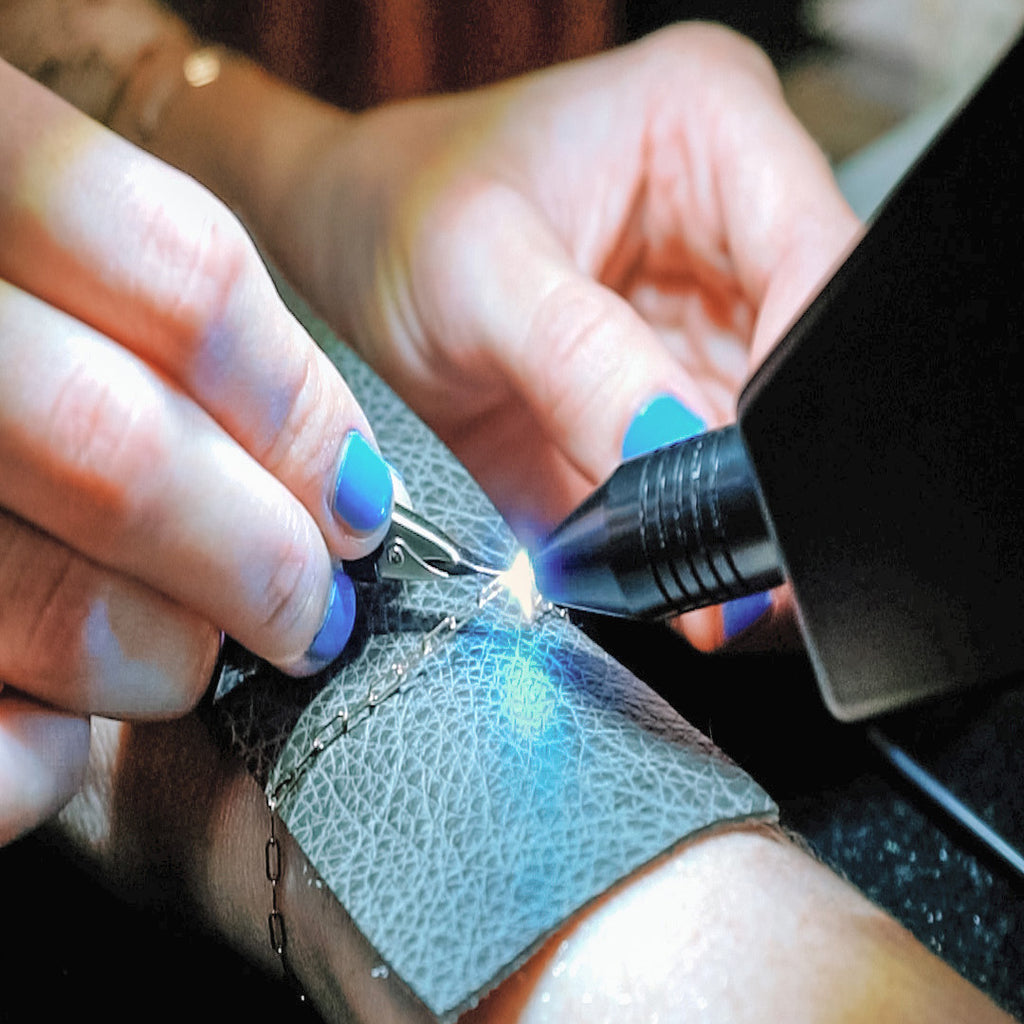 a silver permanent bracelet being applied