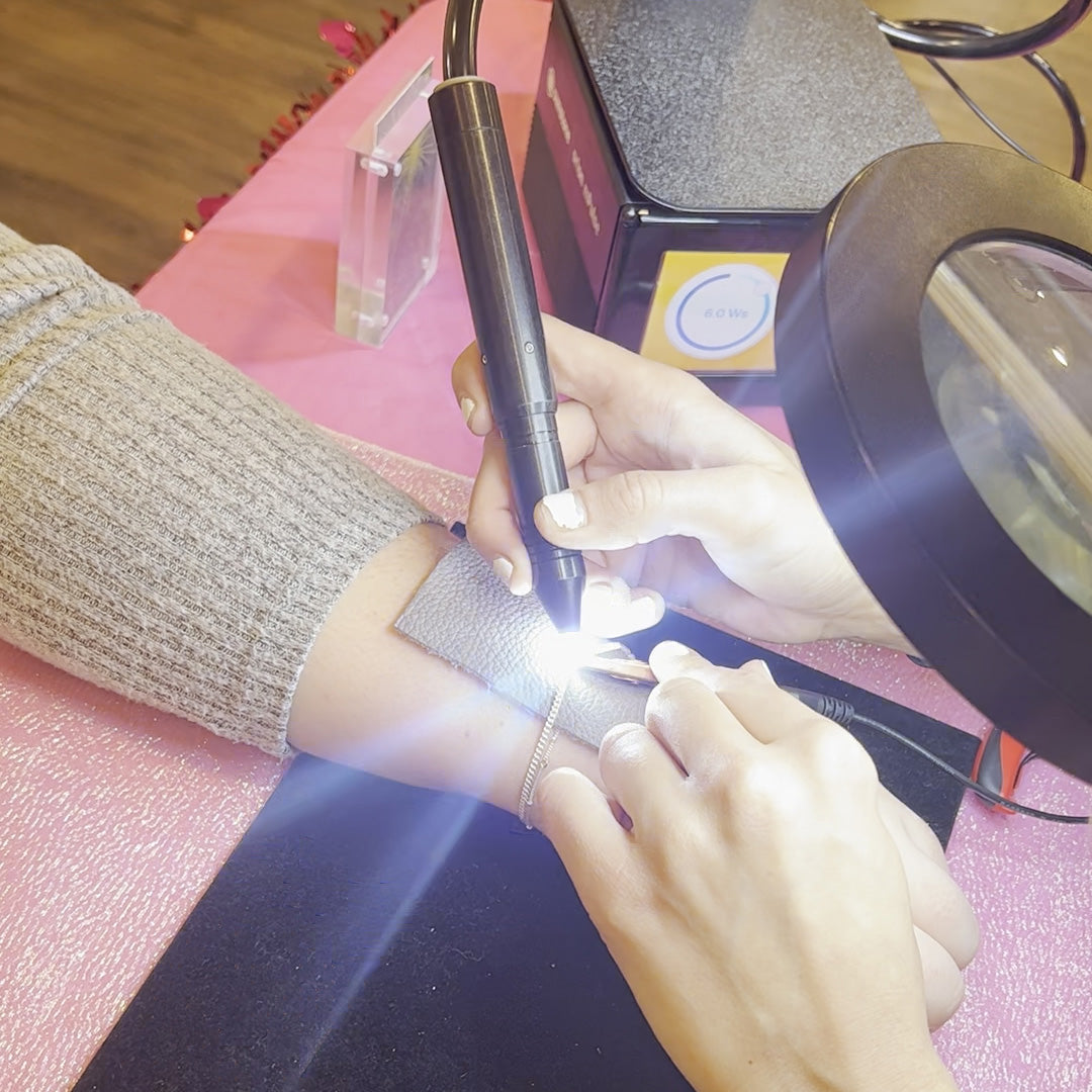 a gold permanent bracelet being welded on